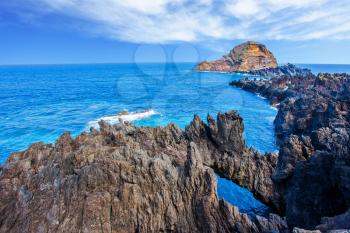 Volcanic island of Madeira. Fantastically beautiful coast. Rocks and grottoes of the Atlantic coast. The concept of exotic and ecological tourism