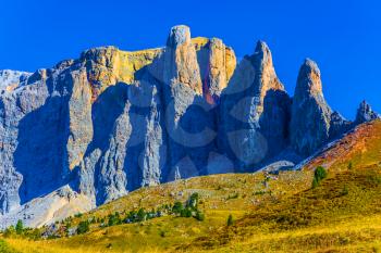 The most beautiful route in the Italian Dolomites. Southern Limestone Alps. The majestic white and gray rocks are illuminated by the morning sun. The concept of active and car tourism