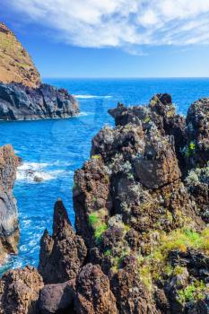 Magic travel on the fantastic island of Madeira. Rocks and stones on shores of the volcanic island of Madeira. Concept of exotic and ecological tourism