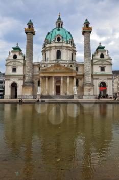 VIENNA, AUSTRIA - SEPTEMBER 26, 2013: Saint Karl Borromey's well-known church in Baroque style. On the square big pond