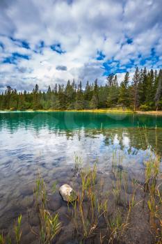 Jasper National Park, lake Annette, Canadian Rocky Mountains.  The picturesque oval lake with clear water