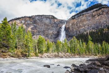 Autumn day in Yoho National Park in the Rocky Mountains of Canada. Colossal Takakkaw waterfall formed by melting glacier Daly