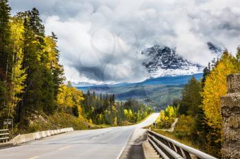 The astonishing road 93 Icefields Parkway passes among the snow-capped mountains. The grandiose nature of the Rockies of Canada. The concept of active and automobile tourism