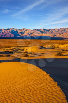 Small sandy ripples on orange barkhans. Mesquite Flat Sand Dunes in California