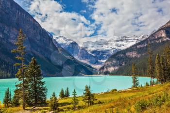 Magnificent Lake Louise is surrounded by mountain peaks and glaciers. Rocky Mountains, Canada, Banff National Park. Great sunny day