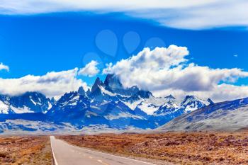 Fine highway to the grandiose Mount Fitz Roy. Argentine Patagonia. Summer day in February. The concept of active and extreme tourism. Summer sun and blue sky above the prairie