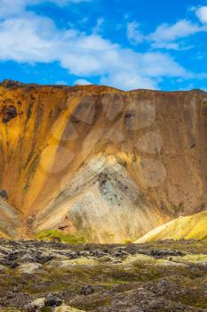  Bright and multi-colored rhyolite mountains - orange, yellow, green and blue. Travel to Iceland in July,  volcanic summer tundra