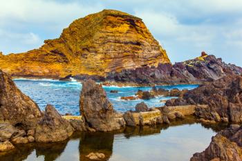 Fantastically beautiful coast. Rocks and grottoes of the Atlantic coast. Volcanic island of Madeira. The concept of exotic and ecological tourism