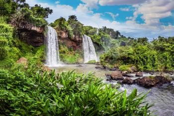 Two powerful fairy waterfalls from Iguazu Falls in Argentina. The concept of extreme and ecological tourism. Picturesque ledges form the famous waterfalls