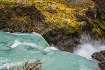 Travel to Patagonia. Turquoise water is a powerful waterfall Salto Grande. Concept of active and ecological tourism