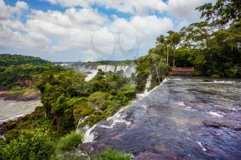  Argentina. Fairy waterfalls from Iguazu Falls. The concept of extreme and ecological tourism. Scenic basaltic rock formations form the famous waterfalls