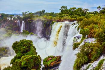 The full-flowing waterfall in the world - waterfalls Iguazu in the rainy season. Concept of active and ecological tourism