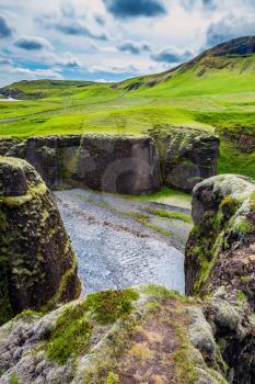 The beautiful canyon in Iceland - Fyadrarglyufur. Steep cliffs surround the stream of very cold water