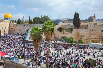 The Western Wall of the Temple. Autumn holiday of Sukkot in Jerusalem. At Temple Square was a huge crowd of Jews