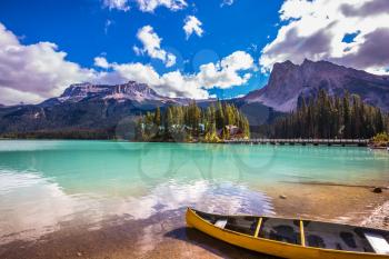 In shallow water the boat is moored. The mountain Emerald lake Yoho National Park. The concept of eco-tourism and active tourism