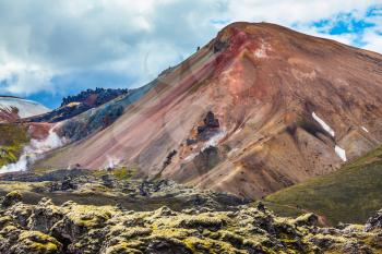Travel to Iceland in the summer. National park Landmannalaugar. Multi-color rhyolitic mountains are lit with the July sun