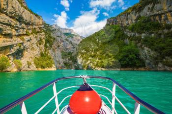 Travel to Provence. Azure water of the river Verdon. Pleasure boat with the red lantern