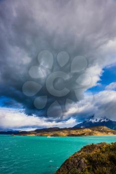 A giant cloud over the picturesque lake Pehoe. Torres del Paine National Park - Biosphere Reserve.  Chile, Patagonia