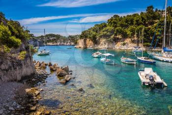 National park of Calanques in Provence, between Marseille and Kassis. The picturesque gulf with turquoise water at coast of the Mediterranean Sea. Graceful sailing yachts in the sea fjord
