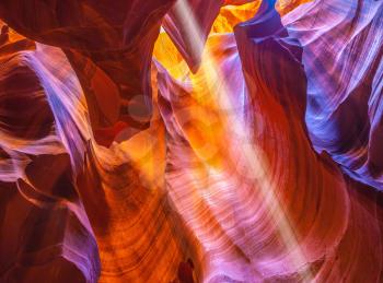 Magic ray of sunshine in the colored fantastic slot canyon Antelope.  The Navajo reservation, Arizona, USA