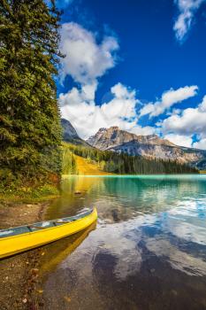 In shallow moored boat. The concept of eco-tourism and active tourism. The mountain Emerald lake.  Sunny day in autumn Yoho National Park 