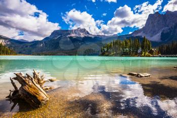 The concept of eco-tourism and active recreation. Yoho National Park in Canada. Mountain Emerald lake in the wooded mountains. Sunny day in autumn