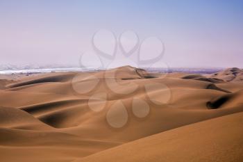 Atlantic in Namibia, Africa. Giant sand dunes on the ocean coast. The concept of exotic and extreme travel
