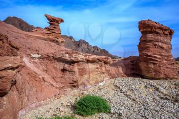 Outcrops of pink sandstone unusual forms. Israel.  Dry mountains of Eilat on a warm day in January