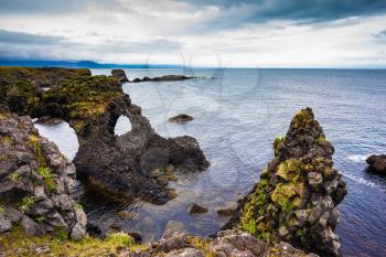Magical coastal cliffs fishing village Arnastapi. July day in Iceland