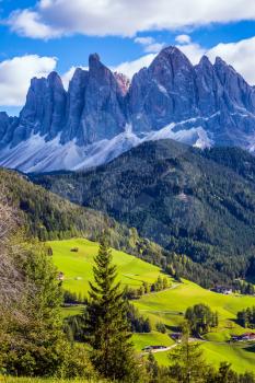 Lovely sunny day in Naturpark Puez-Odle. Dolomites, Val de Funes valley. Odle mountain peaks around the valley