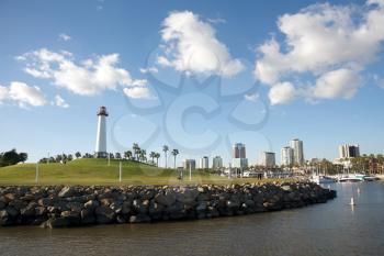 Royalty Free Photo of a Lighthouse With an Urban Centre in the Background