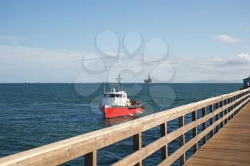 Royalty Free Photo of a Ship From a Boardwalk
