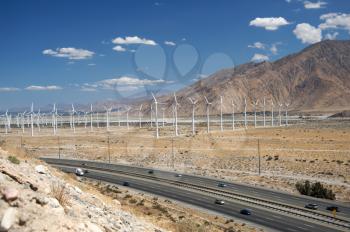 Royalty Free Photo of a Wind Farm By a Mountain