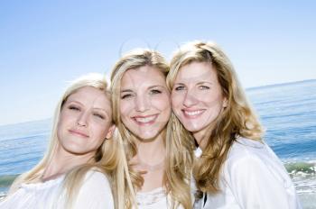 Royalty Free Photo of Three Women Smiling on the Beach