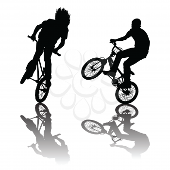 Silhouettes of bikers doing tricks