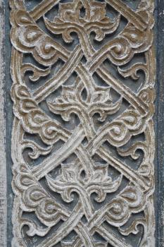 Old abstract design decorative bas relief on stone wall