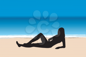 Young woman silhouette lying on the beach by the sea