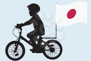 A kid silhouette rides a bicycle with Japan flag