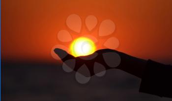 Close up of woman hand holding sun in hand