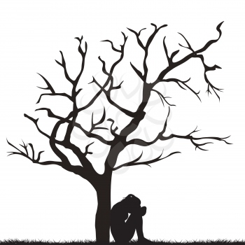 Silhouette of a sad young woman under a leafless tree 