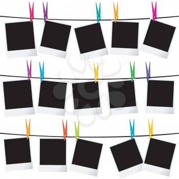 Empty photo frames on ropes with colorful clothespins