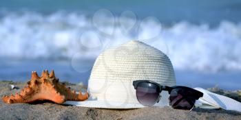 Summer concept, isolated sunglasses, starfish and hat