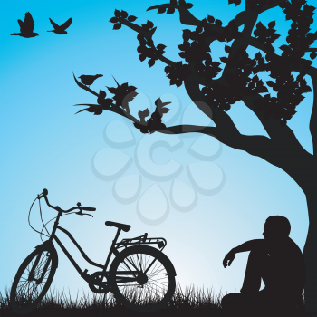 Relaxing bicyclist  under a tree
