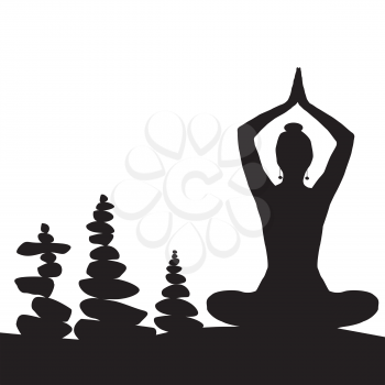 Silhouette of woman in yoga posture and balanced stones