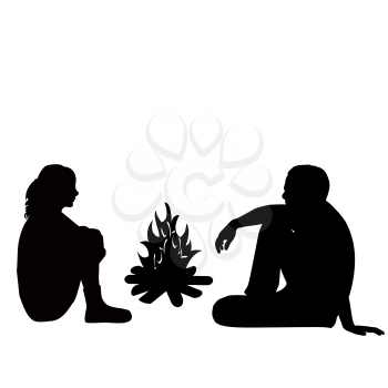 Silhouette of a man and woman sitting by the fire