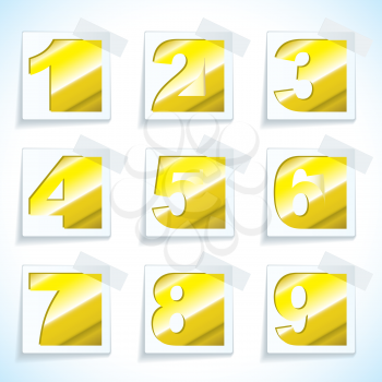 Collection of number paper tags in gold metal with light reflection