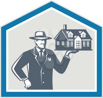 Illustration of real estate salesman sales agent wearing hat holding a house on his hand set inside shiled on isolated background done in retro style.