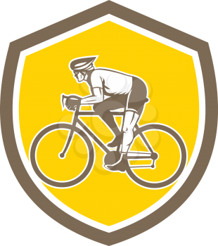 Illustration of a cyclist biking riding mountain bike viewed from the side set inside shield crest on isolated background done in retro style. 