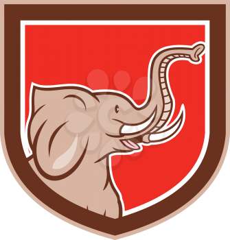 Illustration of an elephant head with tusks viewed from the side set inside shield crest on isolated background done in cartoon style.