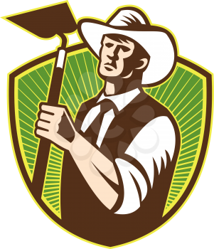 Illustration of organic farmer holding a grab hoe facing front set inside shield with sunburst in the background done in retro style.